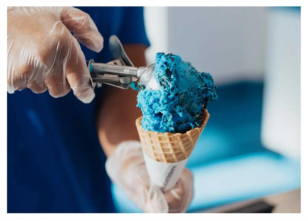 Handel's employee scooping ice cream