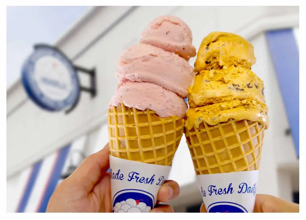 two ice cream cones in front of a Handel's ice cream shop