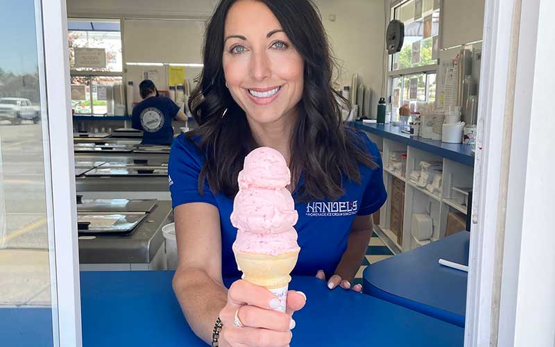 Handel's Ice Cream franchisee Leigh Jaffer serving a strawberry ice cream cone